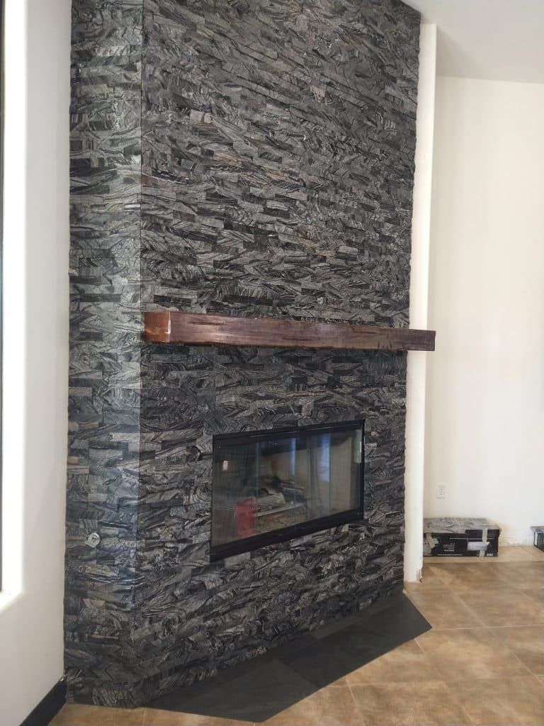 Fireplace after: charcoal ledger stone with a new mantel